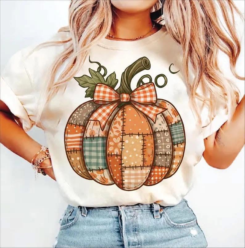 Patchwork pumpkin with orange gingham bow on cream shirt