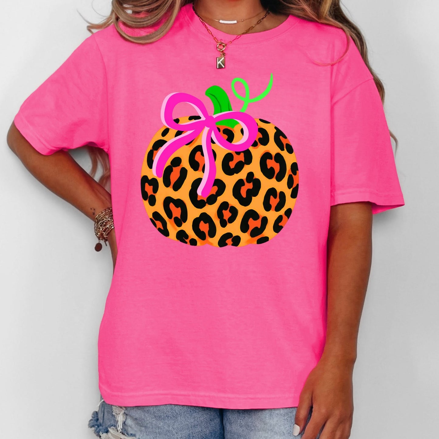 Leopard pumpkin with hot pink bow on pink shirt