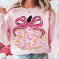 Pink and gold pumpkin with satin-style bow on pink sweatshirt